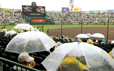 　午後６時、阪神-ＤｅＮＡ戦の中止アナウンスが流れ、傘を持つファンも残念そう＝甲子園