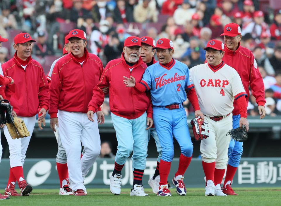 　紅白戦に勝利し、選手と一緒にグラウンドに出る監督を務めた広島ＯＢ・安仁屋宗八氏＝２９日