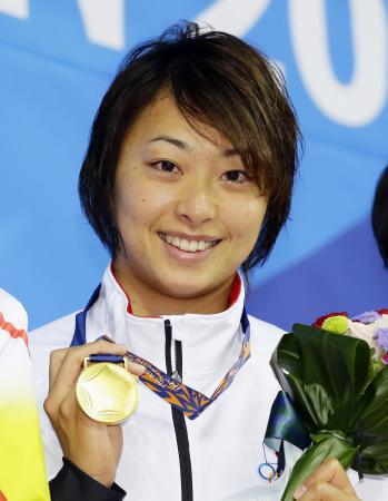 　女子５０メートル平泳ぎで優勝し、笑顔で金メダルを手にする鈴木聡美＝仁川（共同）