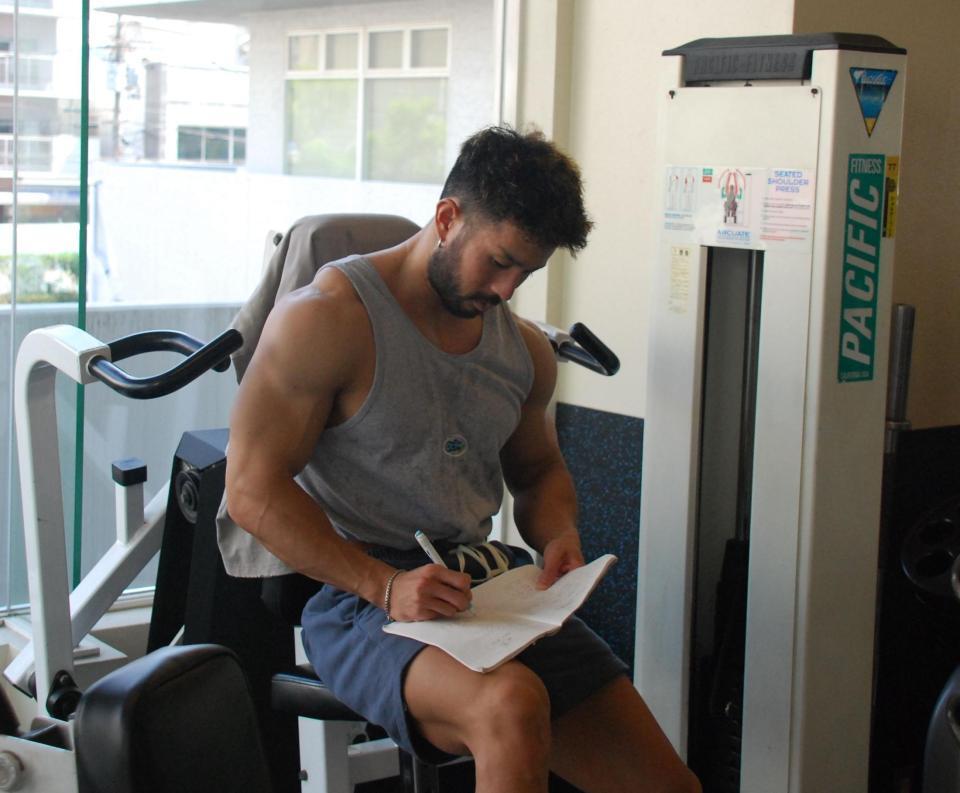 　インターバルでメモを書く伊吹選手（撮影協力：ゴールドジム十三店）