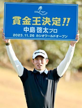 　男子ゴルフで賞金王に決まり、ボードを掲げる中島啓太＝２６日、Ｋｏｃｈｉ黒潮ＣＣ