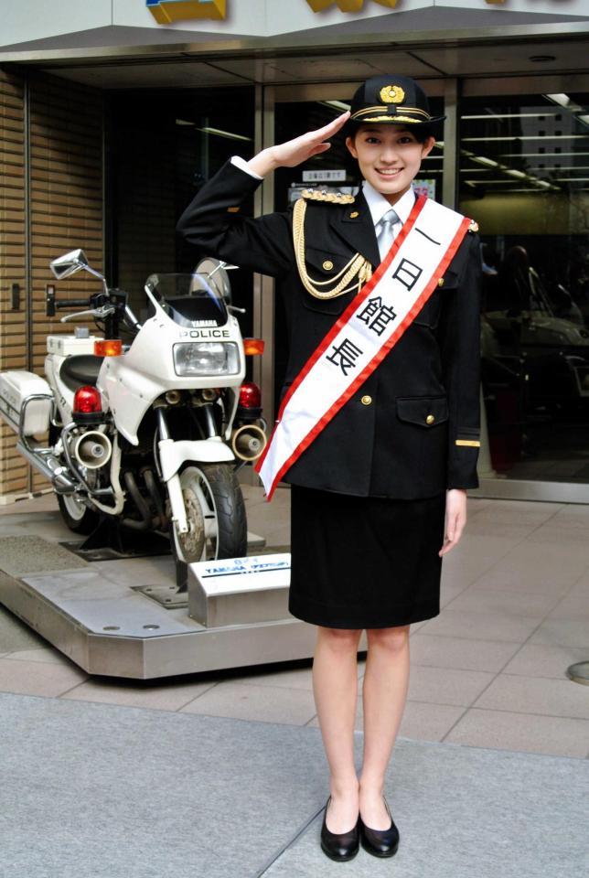 　白バイの前で敬礼ポーズを決める吉本実憂＝東京・警察博物館