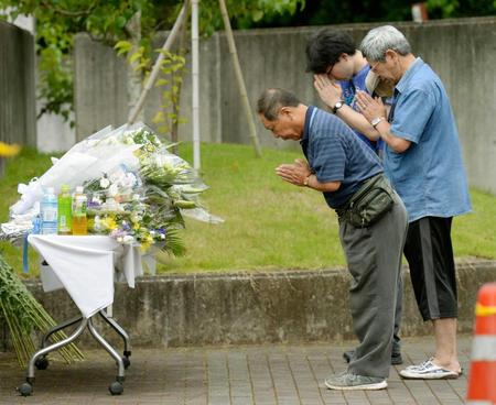 　「津久井やまゆり園」の献花台で、犠牲者を悼み手を合わせる人たち＝２８日午前、相模原市緑区