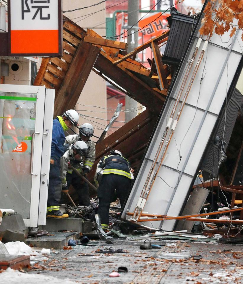 爆発のあった建物付近を調べる消防隊員ら＝札幌市豊平区　