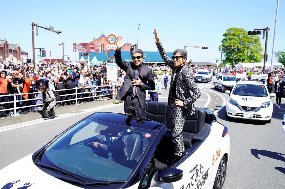 　「ザよこはまパレード」でオープンカーに乗り、沿道に詰めかけた観客に応える舘ひろし（左）と柴田恭兵
