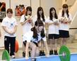 　４０キロのバーベルを持ち上げようとするＡＫＢ４８・佐藤すみれ（前）を見守る（右から）阿部マリア、武藤十夢、小嶋菜月、名取稚菜と三宅宏実＝東京国際フォーラム（撮影・北野将市）
