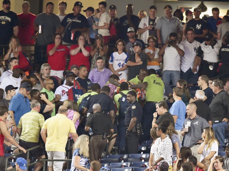 　ターナー・フィールドの観客席から転落したファンの周囲で心配そうな人たち