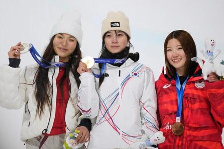 女子ハーフパイプで金メダルを獲得した崔ガオン。左は銀メダルのクロイ・キム、右は銅メダルの小野光希＝リビーニョ（共同）