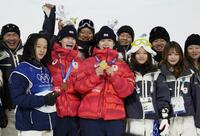 　男子ハーフパイプで金メダルを獲得し、笑顔で集合写真に納まる戸塚優斗（中央）と銅メダルの山田琉聖（同左）＝リビーニョ（共同）
