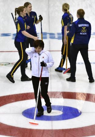 スウェーデン(奥)に敗れて準決勝進出を逃し、悔しそうに引き揚げる小笠原=ソチ(共同)