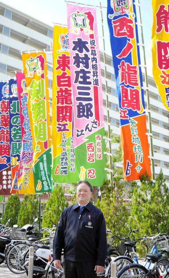 　西岩親方から贈られたのぼりの前に立つ木村庄三郎