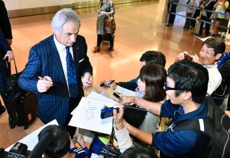 　羽田空港に到着し、出迎えたファンにサインするサッカー日本代表のハリルホジッチ監督＝１４日夜