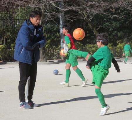 マンツーマン指導する福西崇史氏（左）