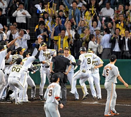 　延長１２回、高山（９）のサヨナラ満塁弾で巨人に勝利し喜ぶ矢野監督（中央左）ら阪神ナイン＝１９年５月２９日
