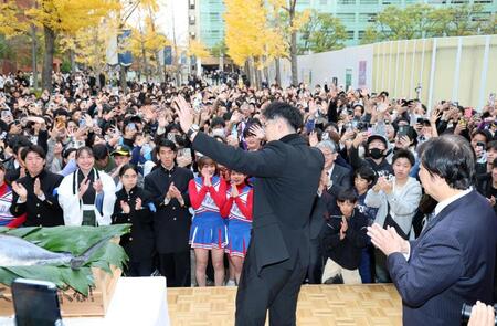 　集まった学生らに手を振り降壇する佐藤輝（撮影・山口登）