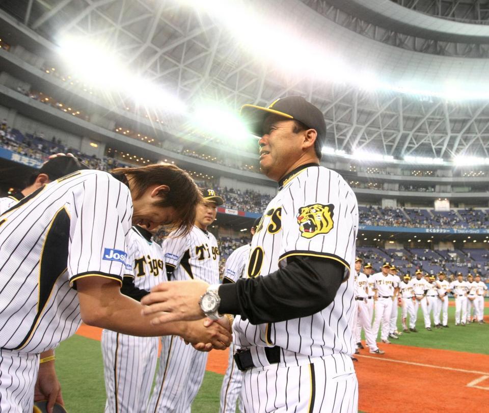 　頭を下げる球児に声をかけ号泣する岡田監督＝０８年