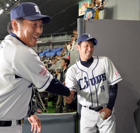 　プロ初勝利を果たし、渡辺監督（左）から祝福される増田