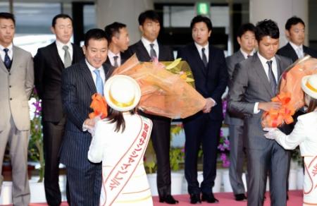 歓迎セレモニーで花束を受け取る巨人・原辰徳監督（左）。右は坂本勇人＝宮崎空港（撮影・開出　牧）