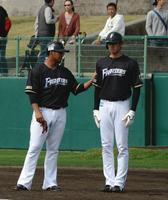 練習中、中田翔（左）に右腕をつかまれ直立不動になる日本ハム・大谷翔平＝名護（撮影・開出牧）