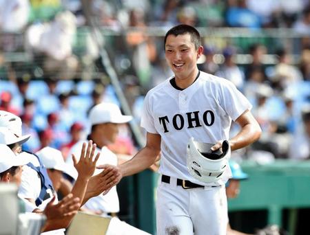 ２回東邦１死満塁、鈴木理央の右犠飛で同点のホームに滑り込みナインとタッチを交わす藤嶋健人＝甲子園（撮影・開出牧）