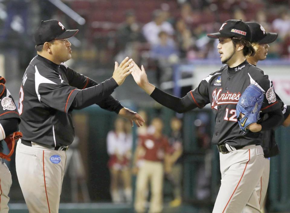 　完封で14勝目を挙げた石川（右）を迎えるロッテ・伊東監督＝コボスタ宮城