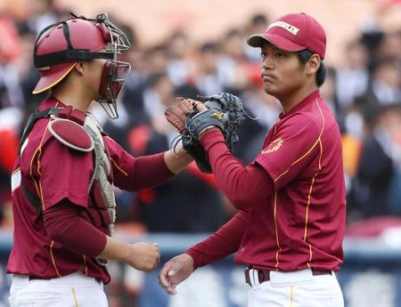 　中央学院大戦で完投勝利を挙げ、大平（左）とタッチを交わす桜美林大・佐々木千