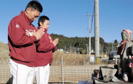 　津波の被害を受けた南三陸町の献花台に手を合わせる嶋（左）と松井裕