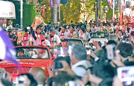 　大勢の人たちが集まる中、優勝祝賀パレードをする立大ナイン