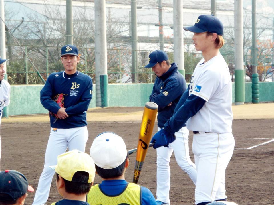 　子どもたちに打撃を教える駿太（右）と大城（左）