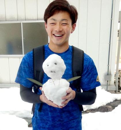 雪だるまを手にして笑顔の成田