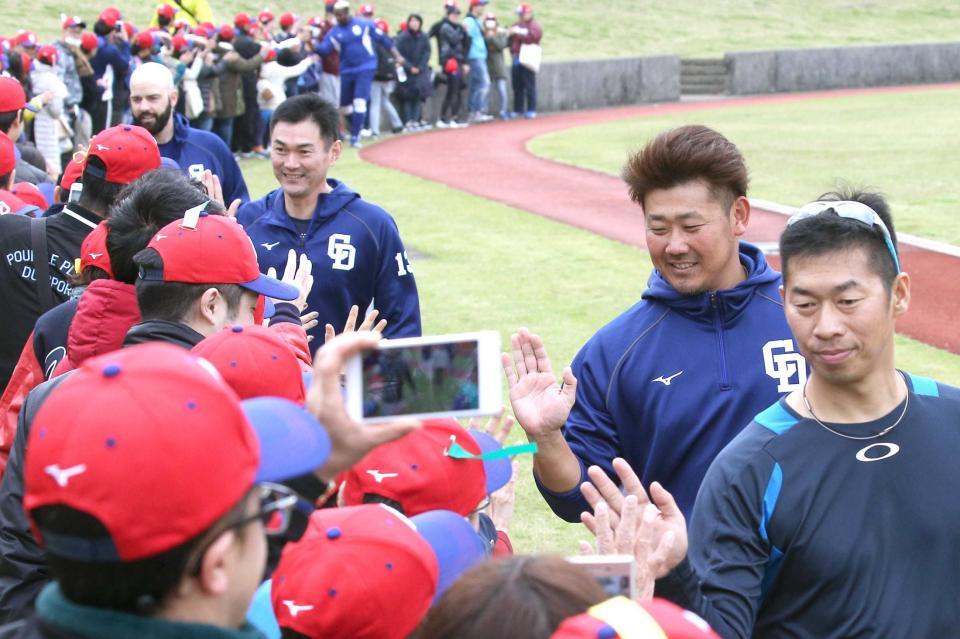 　練習後、大勢のファンとハイタッチする松坂（中央）。右は山井