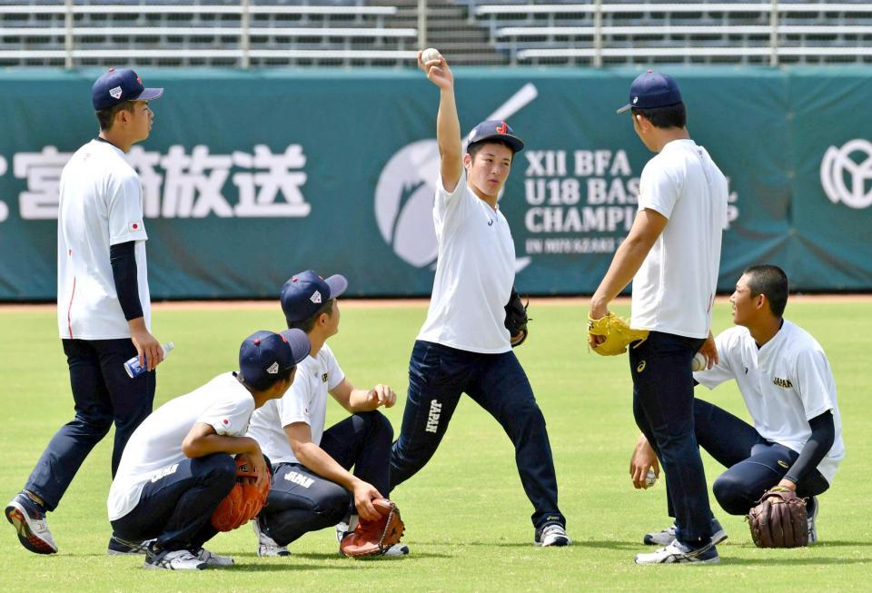 　柿木（右から２人目）ら投手と投球談義する吉田（中央）＝撮影・持木克友