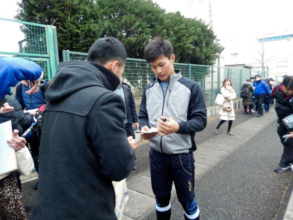 ファンにサインする藤原