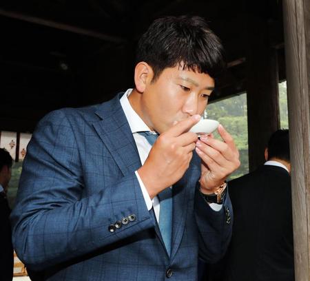 お神酒を口にする巨人・菅野智之＝宮崎神宮