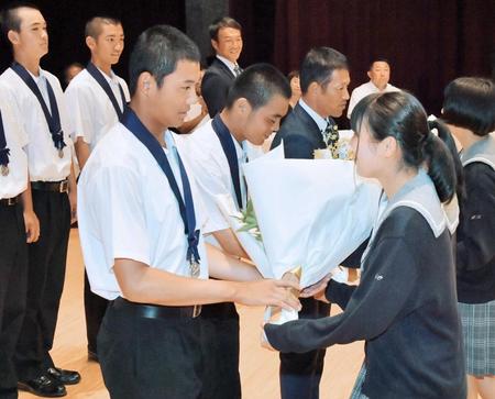 　報告会で花束を受け取る星稜の（手前から）奥川、山瀬主将、林監督（撮影・泉竜太郎）