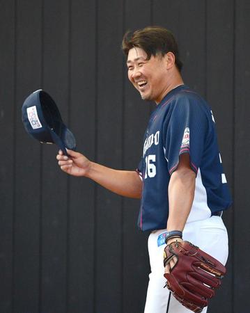 　ブルペンでの投球練習を終え、観客から拍手を送られて笑顔を見せる松坂