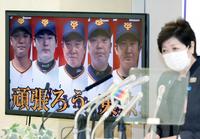 　東京都・小池百合子知事の記者会見で寄付について紹介され、モニターに映る（左から）坂本、丸、原監督、阿部２軍監督、菅野