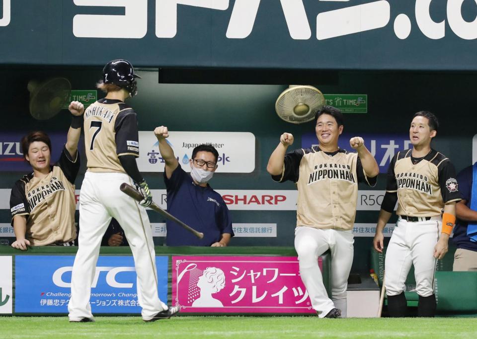 　７回、近藤の適時打で生還した西川（７）を迎える日本ハムナイン＝ペイペイドーム