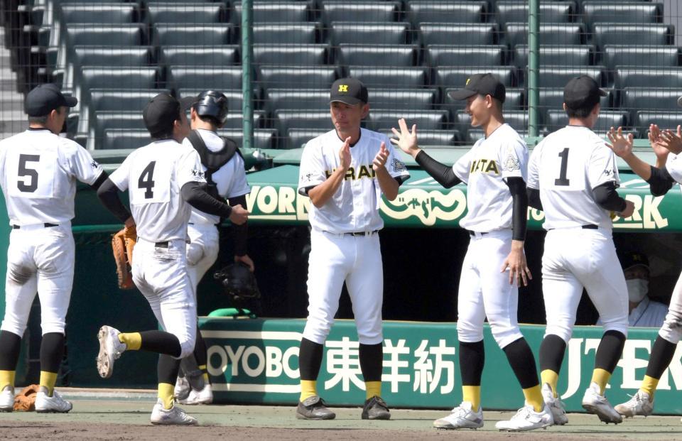 　守備を終えたナインを迎える平田・植田監督（中央）（撮影・山口登）