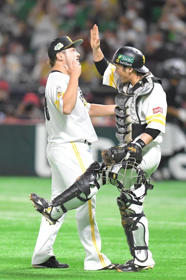 試合に勝利し、ソフトバンク・甲斐（右）とタッチするソフトバンク・森＝ペイペイドーム（撮影・高石航平）