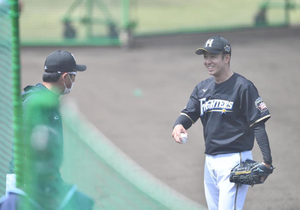　登板を終え、笑顔でコーチと言葉を交わす日本ハム・斎藤佑樹（右）（撮影・高石航平）
