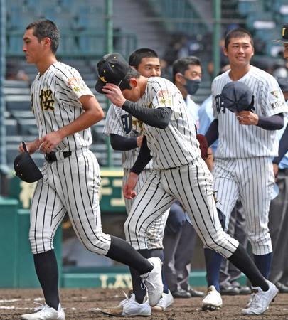 　明徳義塾に敗れ、あいさつを終えたノースアジア大明桜・風間（中央）はベンチ前へ向かう（撮影・北村雅宏）