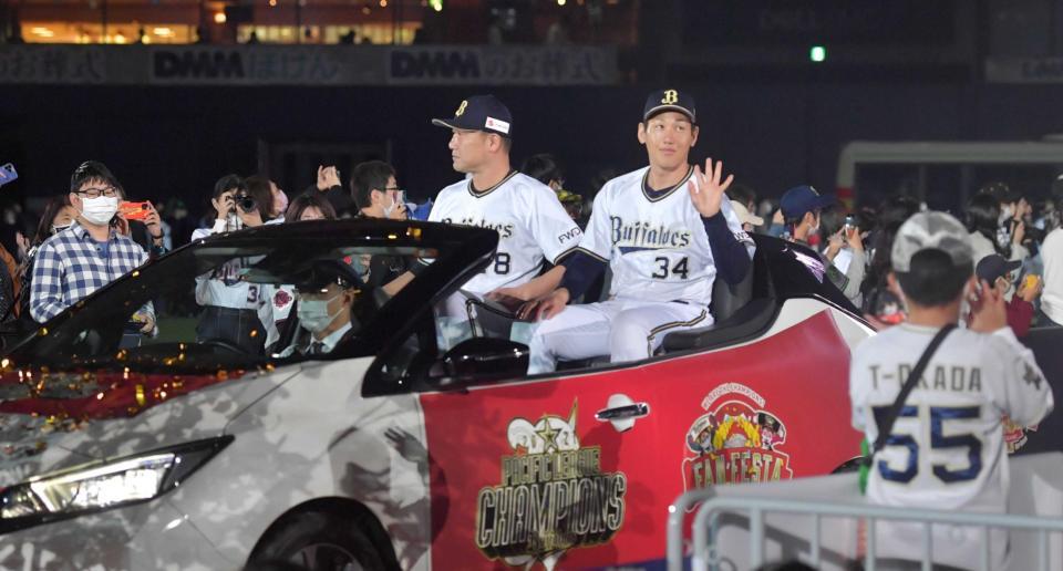 　オープンカーに乗り込みファンに手を振る吉田正（右）と中嶋監督（撮影・神子素慎一）