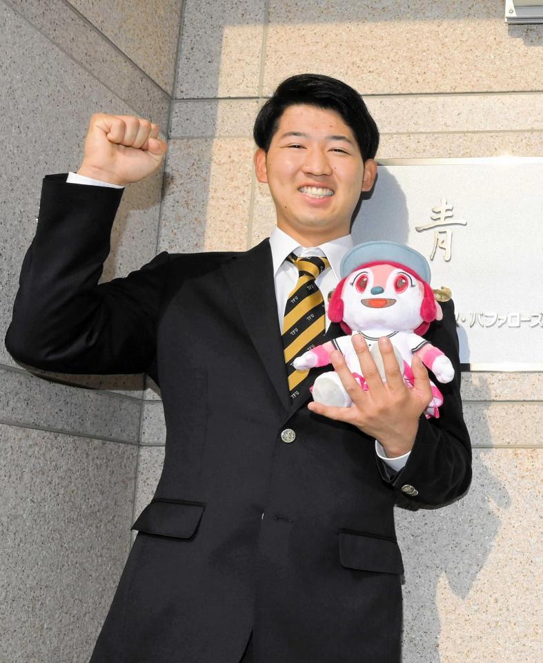 　舞洲の施設見学を終え、寮の看板の前でポーズを決める椋木（撮影・高部洋祐）