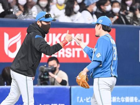 ４回、好リリーフを見せた西村（右）を迎える新庄ビッグボス（撮影・飯室逸平）