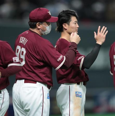 　試合に勝利し、楽天・西川（右）とともにナインを迎える石井監督（撮影・中島達哉）