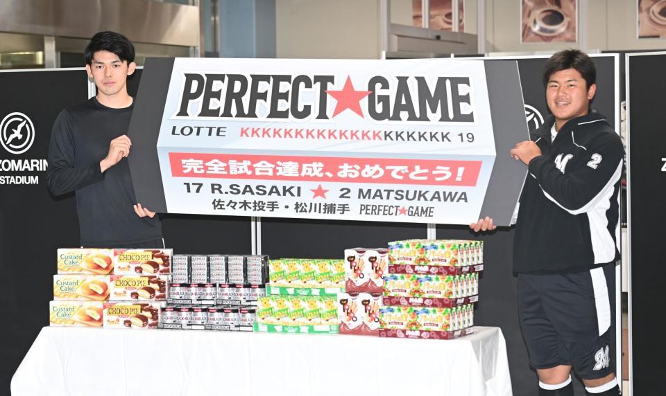 完全試合を祝うボードを手にガッツポーズする佐々木朗（左）と松川（撮影・高石航平）