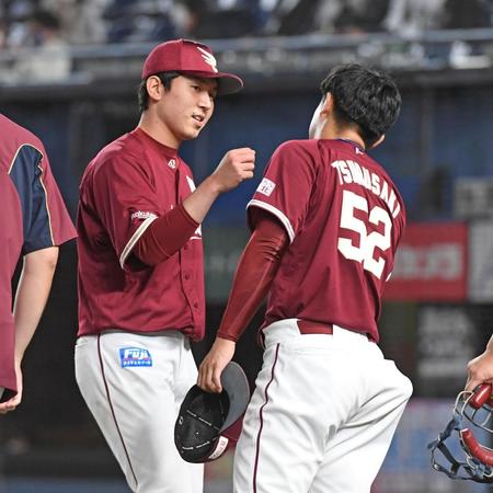 　１１回、サヨナラのピンチを乗り切り、降板した津留崎から出迎えを受け笑顔をみせる西口（撮影・三好信也）