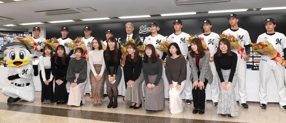 　ロッテの女性社員（前列）から花束を贈られた（後列左から）育成３巡目指名、・勝又琉偉、育成１巡目・吉川悠斗、４巡目・高野修汰、２巡目・友杉篤輝、吉井理人監督、１巡目・菊地吏玖、３巡目・田中晴也、５巡目・金田優太、育成２巡目・白濱快起、育成４巡目・黒川凱星（撮影・佐藤厚）