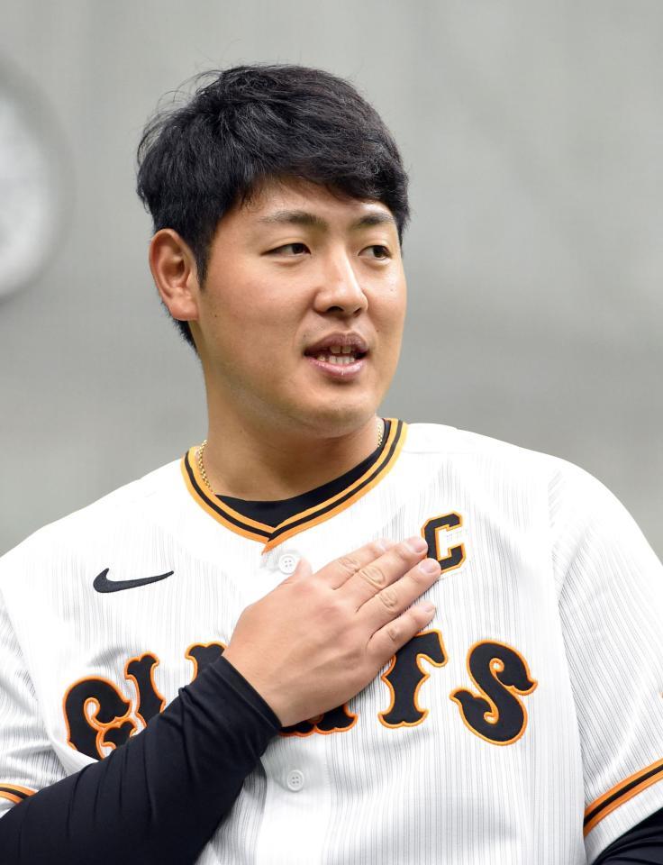 　ユニホームのキャプテンマークを触る岡本和（撮影・佐藤厚）